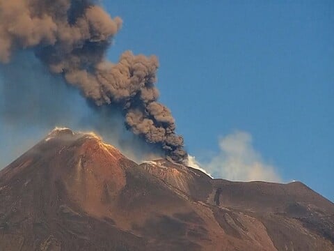 Ash column rising from Mount Etna's summit craters on the live webcam