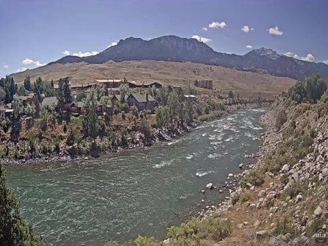 The Yellowstone River running past Gardiner, Montana under a clear summer sky