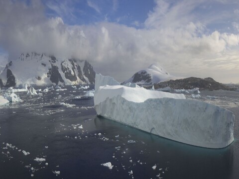 A tabular iceberg and snow covered peaks seen from the Hanseatic Inspiration bow camera