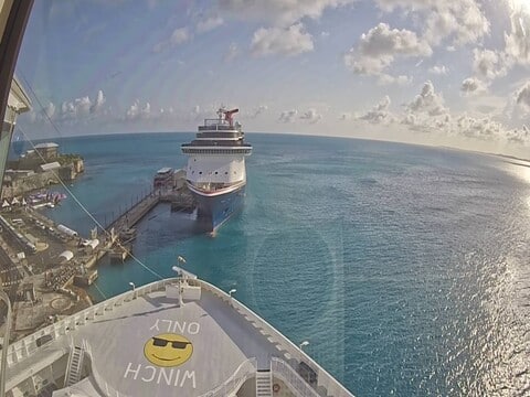 Norwegian Breakaway bow deck with its painted smiley face above clear turquoise water