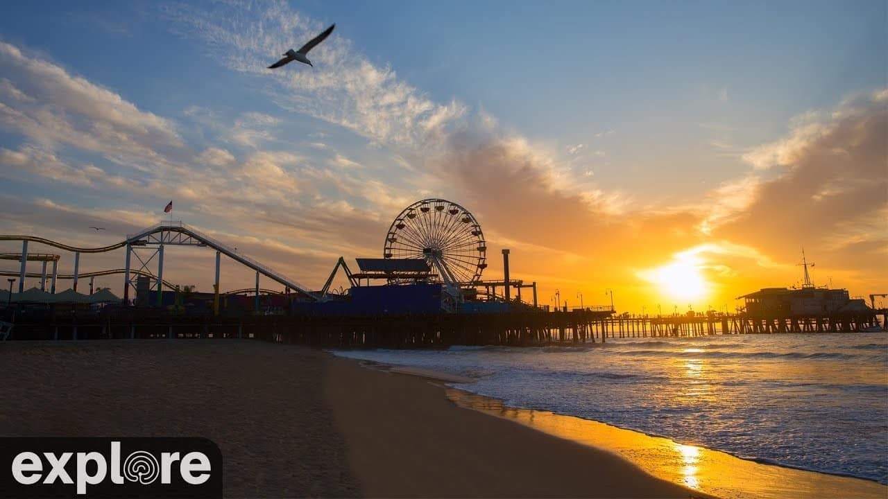 Sunset behind the Santa Monica Pier Ferris wheel and roller coaster on the live webcam