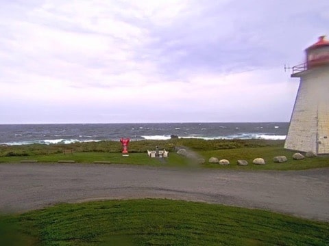 White wooden tower on bare rock above a gray Atlantic at Baccaro Point