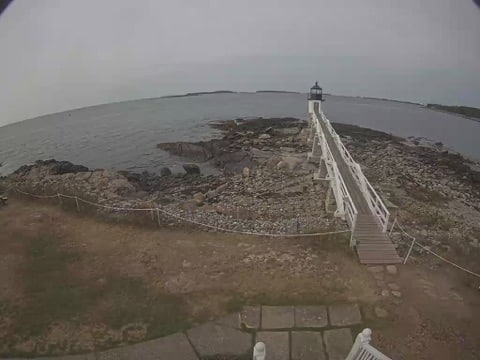 Wooden walkway leading out to the 1857 Marshall Point tower in Maine