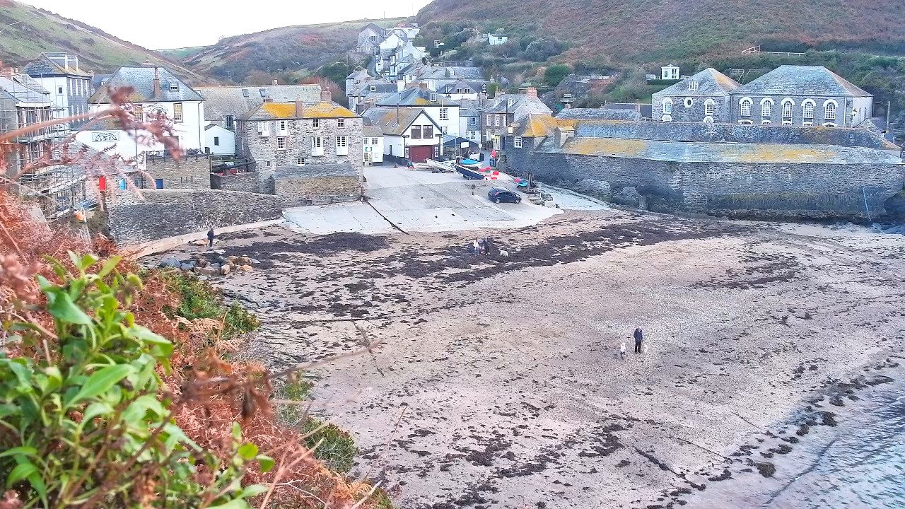 Port Isaac harbor beach, slipway and stone village houses at low tide on the webcam