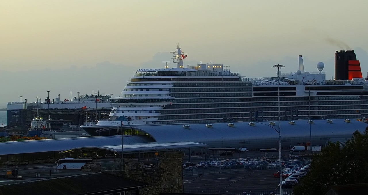 A cruise ship's bow sliding past Southampton's Ocean Terminal at dawn on the webcam
